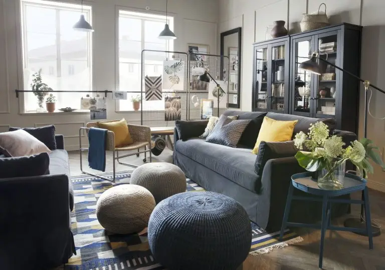 Living room with a sofa, floor lamps and knitted poufs