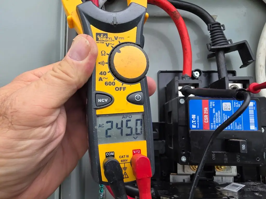 Clamp meter reading 245 volts at a breaker panel