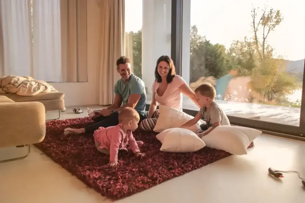 Family relaxing on a living room rug